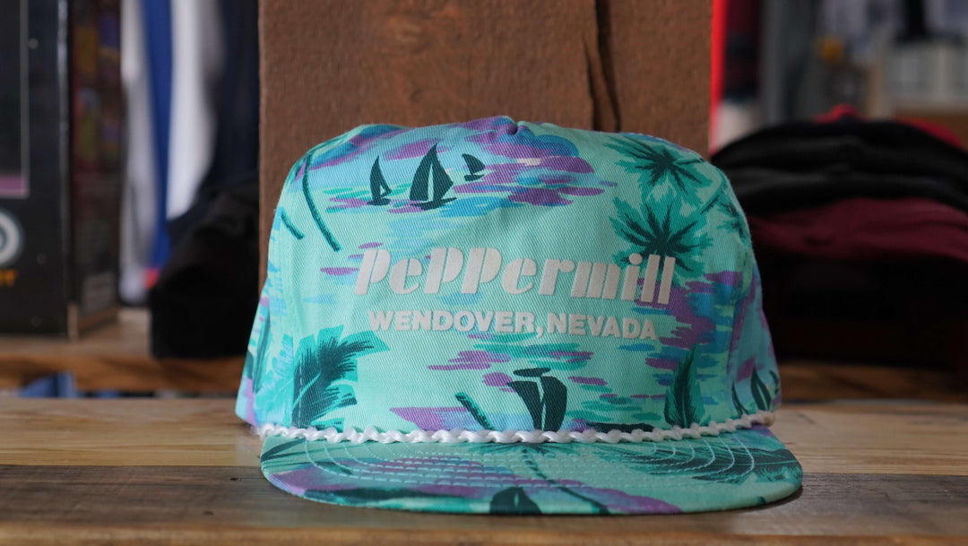 Vintage Peppermill Wendover tropical rope hat with vibrant palm design and casino logo, from West Block Vintage—ideal for enthusiasts of unique country trucker and tropical hats.