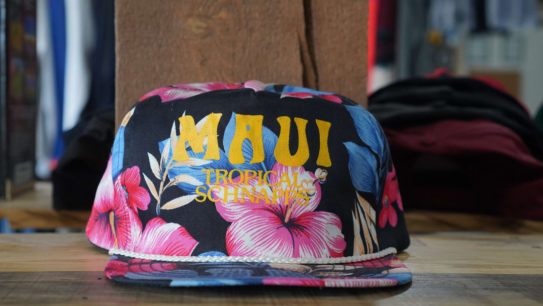 Maui Tropical Schnapps black floral print rope hat with vintage floral design, from West Block Vintage—perfect for collectors of unique country trucker hats.  This content highlights the hat's black floral print rope design, appealing to those interested in stylish hats