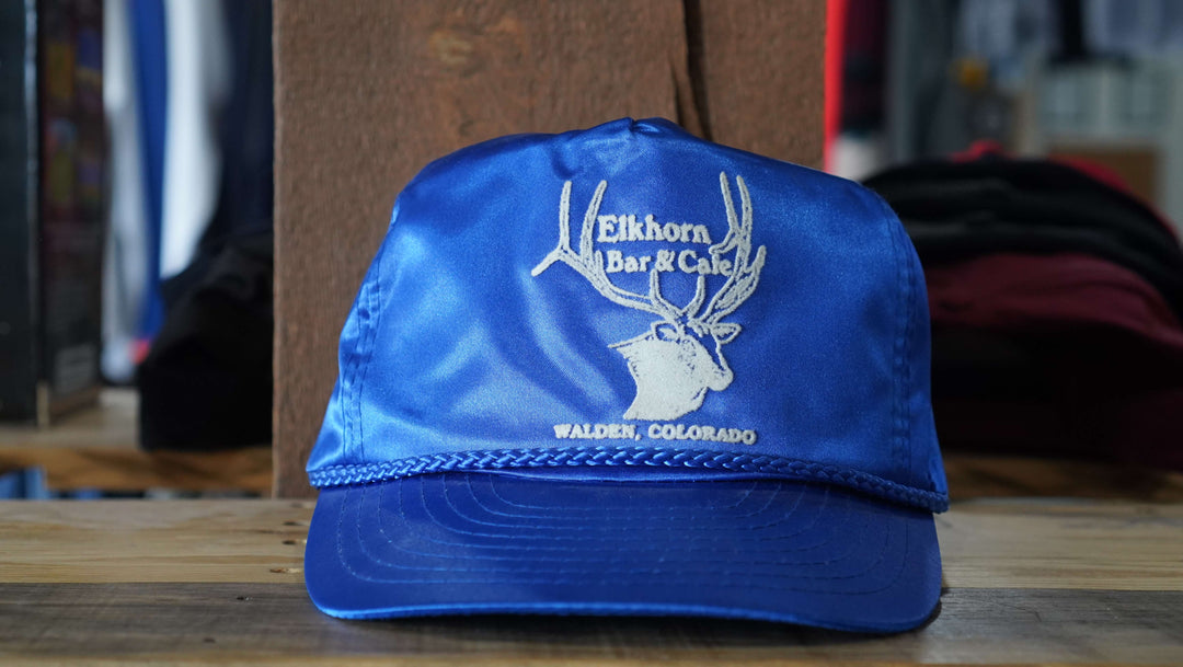 Elkhorn Bar & Cafe blue trucker hat featuring the distinctive logo, from West Block Vintage—ideal for collectors and enthusiasts of classic 90s country trucker hats.
