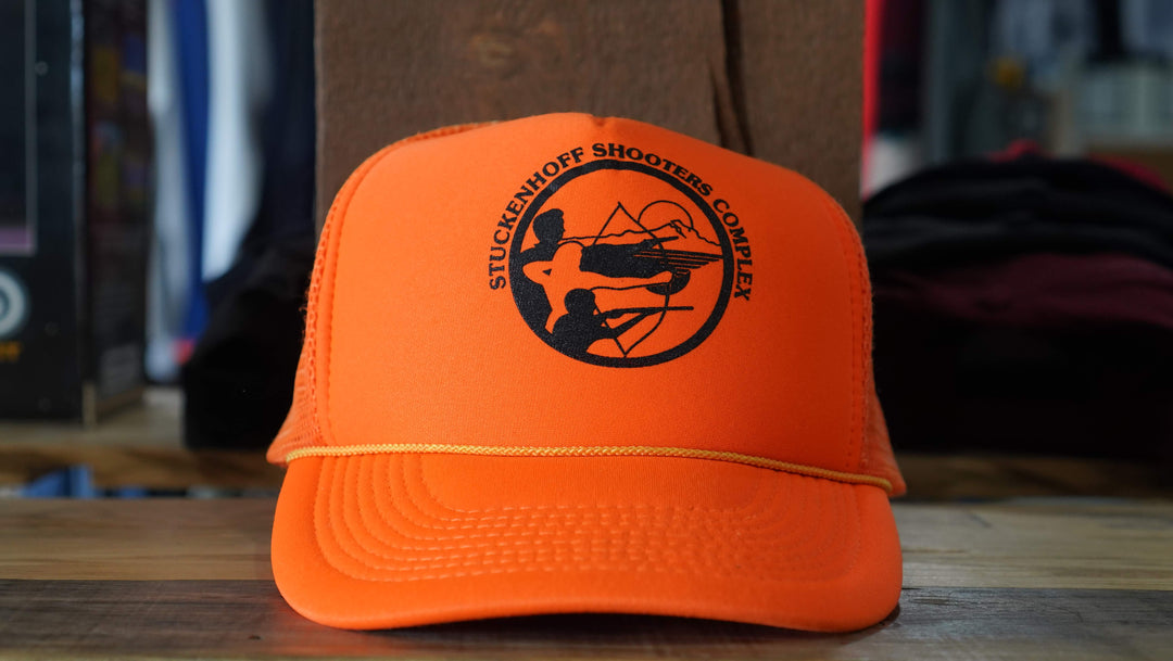 Stuckenhoof Shooters Complex orange trucker hat with vintage rope detail and shooter graphic, from West Block Vintage—ideal for enthusiasts of distinctive 90s hats.